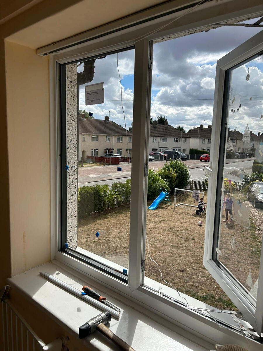 Glazier replacing broken double glazing glass unit in London